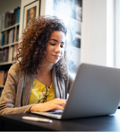 A student looking at a laptop.
